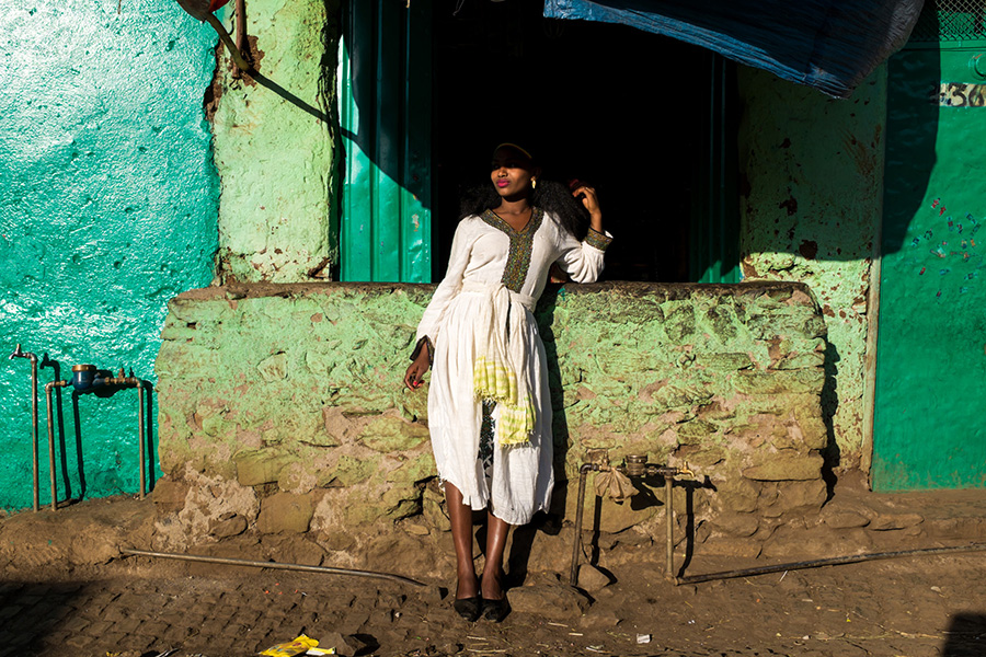 Timkat Gondar. Young woman taking a rest in the sun after the Tabot has return to its altar,